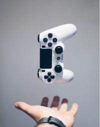 hand throwing up a gaming controller